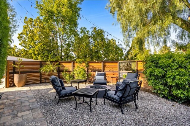 view of patio / terrace with a fire pit and fence