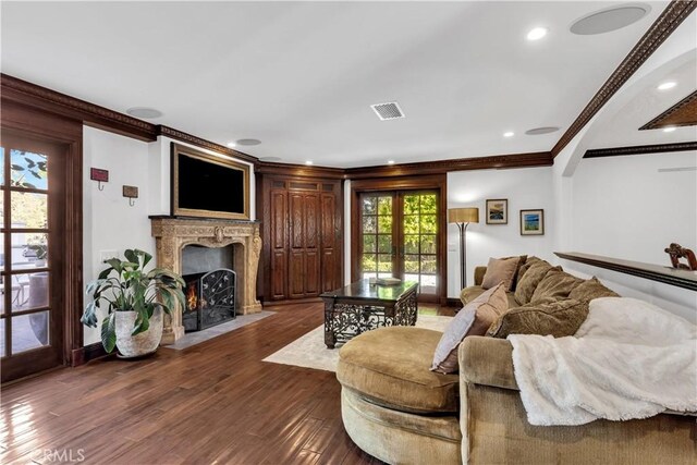 living room with ornamental molding, dark wood-style floors, a high end fireplace, recessed lighting, and baseboards