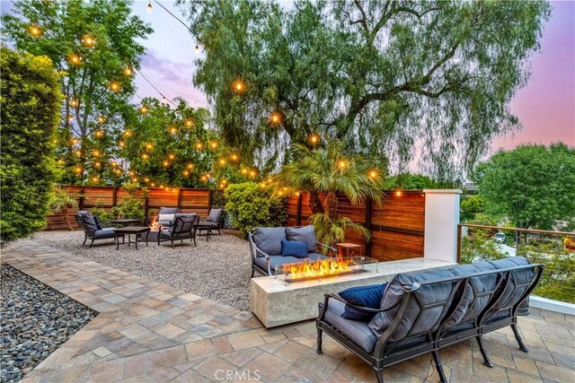 view of patio / terrace featuring an outdoor living space with a fire pit and a fenced backyard