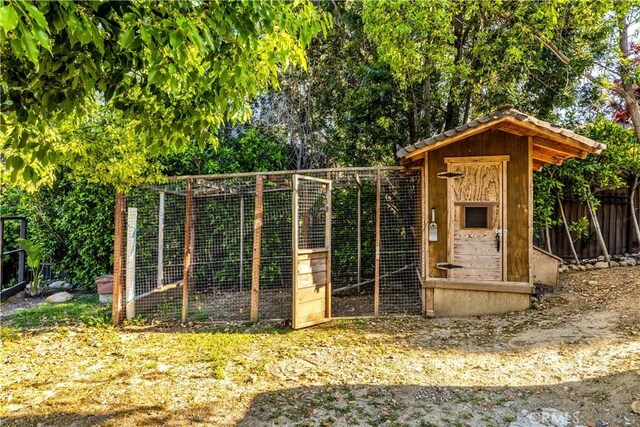 view of poultry coop featuring fence