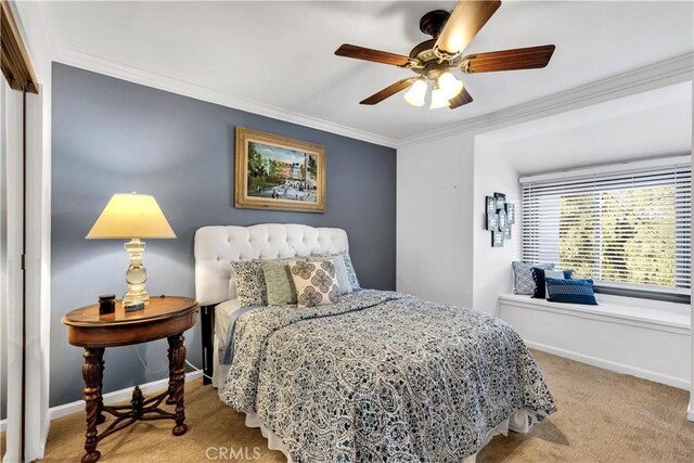 bedroom featuring carpet floors, crown molding, baseboards, and ceiling fan