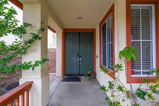 property entrance featuring stucco siding