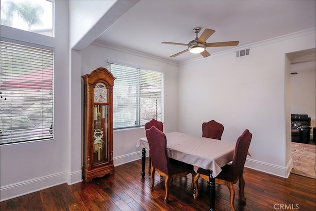 dining room featuring ornamental molding, ceiling fan, wood-type flooring, and baseboards