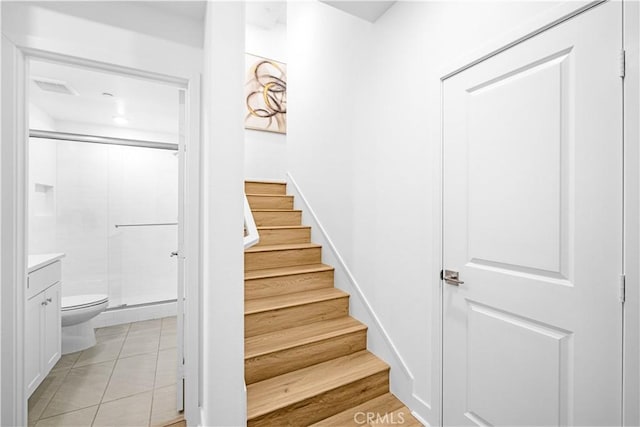 stairway featuring tile patterned flooring