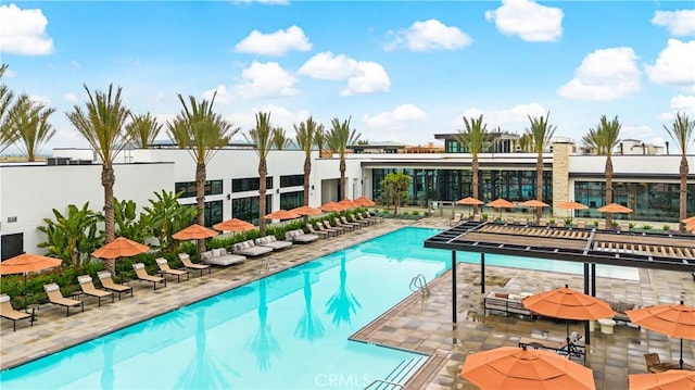 community pool featuring a patio area and fence