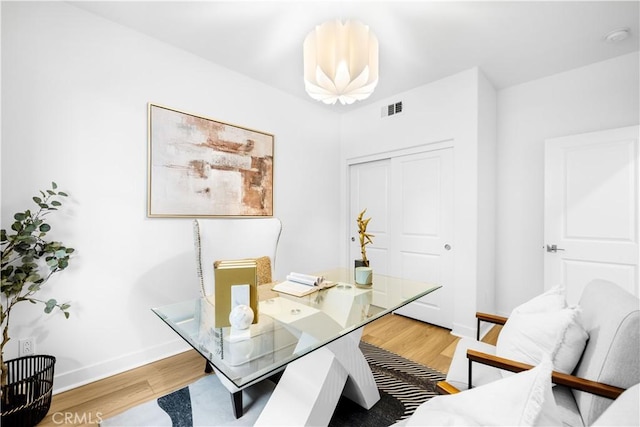 home office featuring wood finished floors and baseboards
