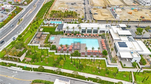 aerial overview of property's location featuring a pool area and a main thoroughfare