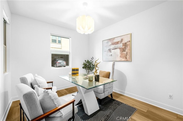 dining room with baseboards and wood finished floors