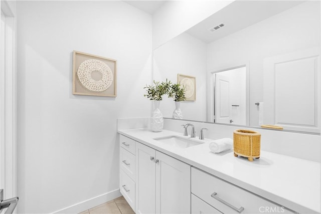 bathroom with vanity, tile patterned floors, and baseboards