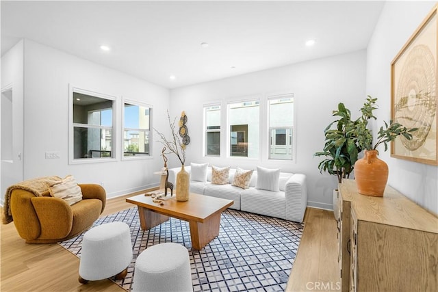 living room featuring plenty of natural light, light wood-style floors, recessed lighting, and baseboards