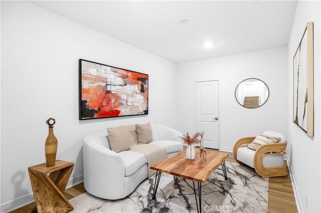living room featuring baseboards, light wood-style flooring, and recessed lighting