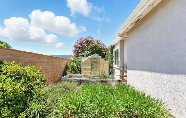 42133 Wagon Wheel Ln, Murrieta, CA 92562 - view of yard with a greenhouse, a vegetable garden, and an outdoor structure