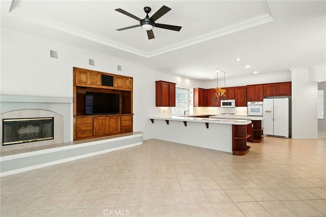 42133 Wagon Wheel Ln, Murrieta, CA 92562 - kitchen featuring white appliances, open floor plan, light countertops, a kitchen bar, and a peninsula