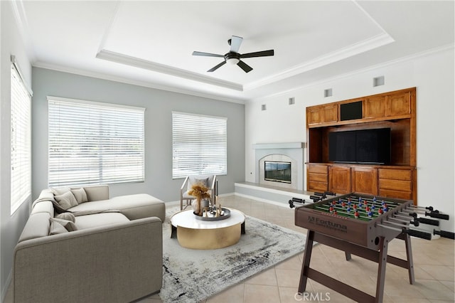 42133 Wagon Wheel Ln, Murrieta, CA 92562 - living room featuring light tile patterned floors, a raised ceiling, plenty of natural light, a ceiling fan, and crown molding