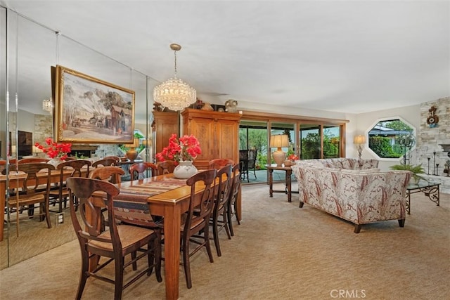 dining area with light carpet and a chandelier
