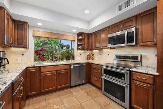 14321 Mimosa Ln, Tustin, CA 92780 - kitchen with stainless steel appliances, a sink, light tile patterned floors, open shelves, and light stone counters