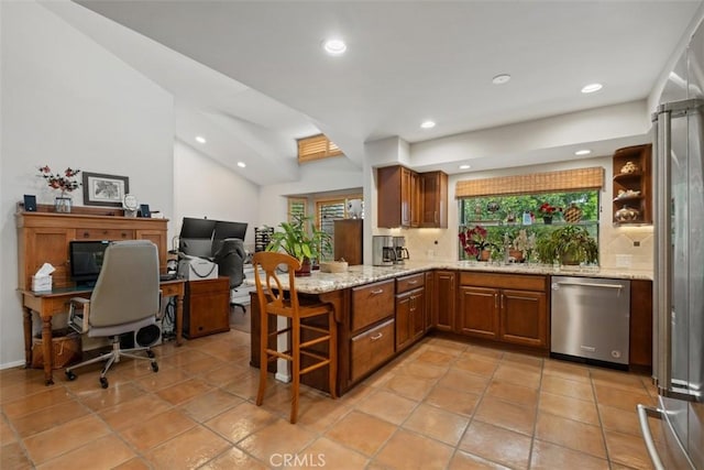 14321 Mimosa Ln, Tustin, CA 92780 - kitchen featuring stainless steel appliances, brown cabinetry, a peninsula, backsplash, and recessed lighting