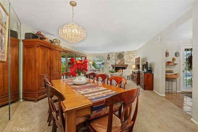 14321 Mimosa Ln, Tustin, CA 92780 - dining space with light carpet, a chandelier, a fireplace, and light tile patterned floors