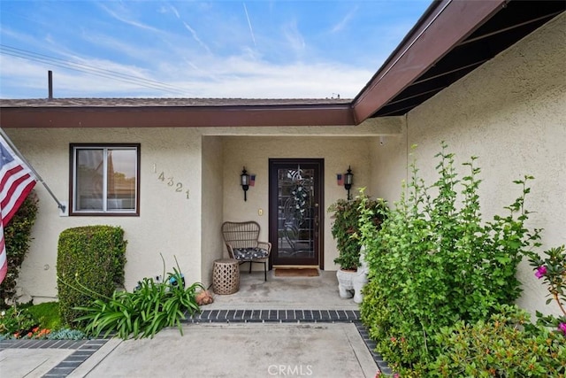 14321 Mimosa Ln, Tustin, CA 92780 - entrance to property with stucco siding and covered porch