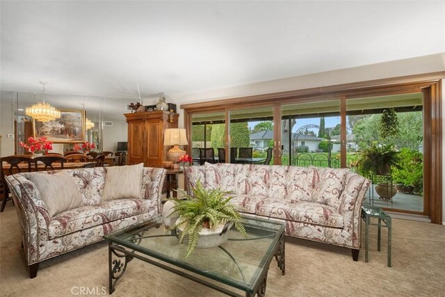 living room featuring a chandelier and light colored carpet