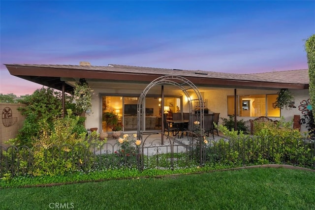 14321 Mimosa Ln, Tustin, CA 92780 - rear view of house with a patio, stucco siding, and a lawn