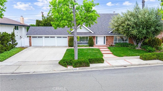 ranch-style home featuring concrete driveway, brick siding, a garage, and roof with shingles