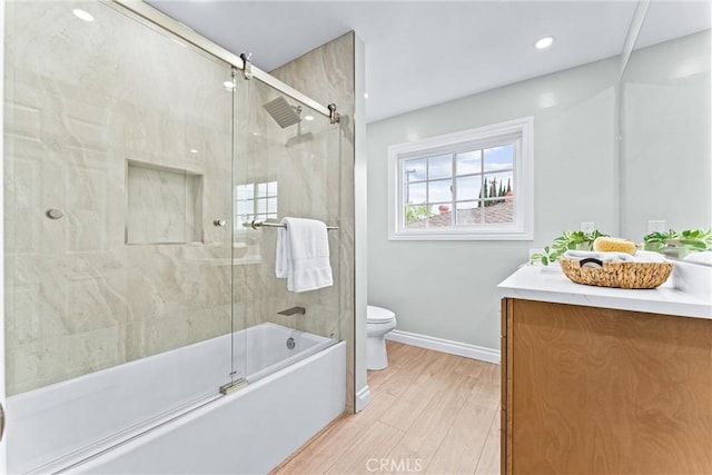 bathroom featuring toilet, vanity, baseboards, shower / bath combination with glass door, and recessed lighting