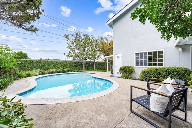 view of pool with a patio and fence