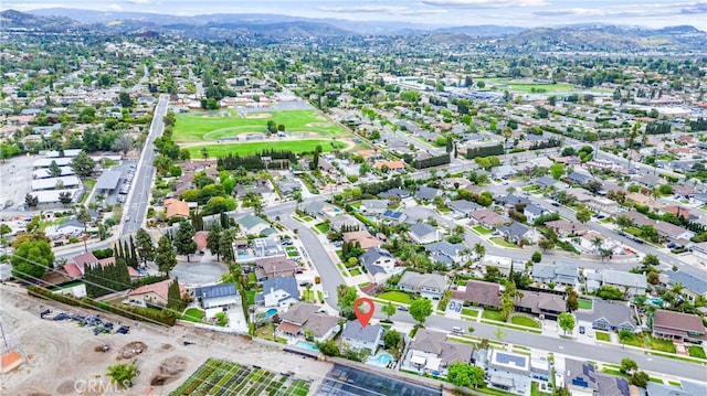 aerial view of property and surrounding area with a mountainous background
