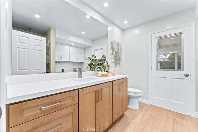 full bath featuring vanity, toilet, recessed lighting, wood finished floors, and a shower