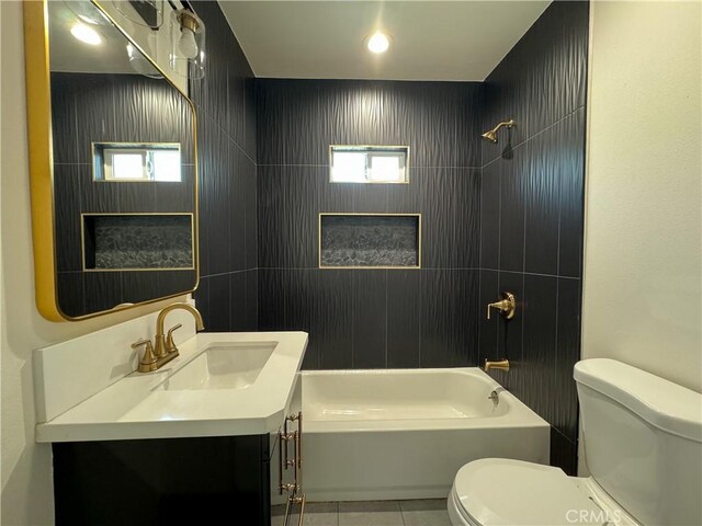bathroom featuring toilet, tile patterned floors, tub / shower combination, and healthy amount of natural light