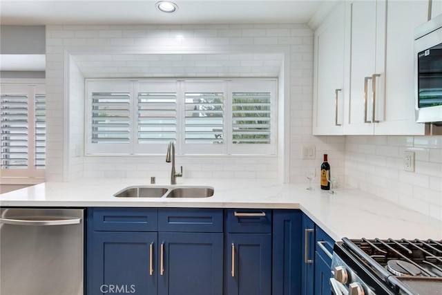 6199 Cabernet Pl, Rancho Cucamonga, CA 91737 - kitchen featuring blue cabinets, a sink, stainless steel appliances, decorative backsplash, and white cabinets
