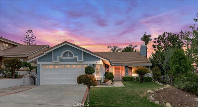 single story home featuring a tile roof, driveway, an attached garage, a front lawn, and a chimney