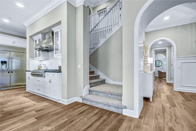 135 Bridle Path, Irvine, CA 92602 - stairway featuring arched walkways, crown molding, wood finished floors, baseboards, and recessed lighting