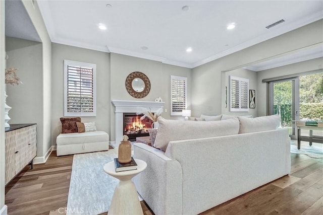 135 Bridle Path, Irvine, CA 92602 - living area featuring wood finished floors, ornamental molding, a glass covered fireplace, recessed lighting, and baseboards