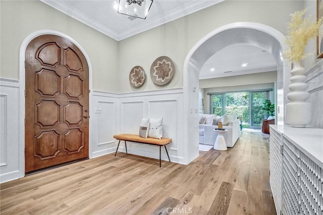 135 Bridle Path, Irvine, CA 92602 - entryway with arched walkways, a decorative wall, light wood-type flooring, wainscoting, and crown molding