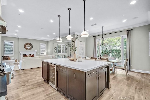 135 Bridle Path, Irvine, CA 92602 - kitchen featuring beverage cooler, ornamental molding, recessed lighting, dark brown cabinetry, and light wood finished floors