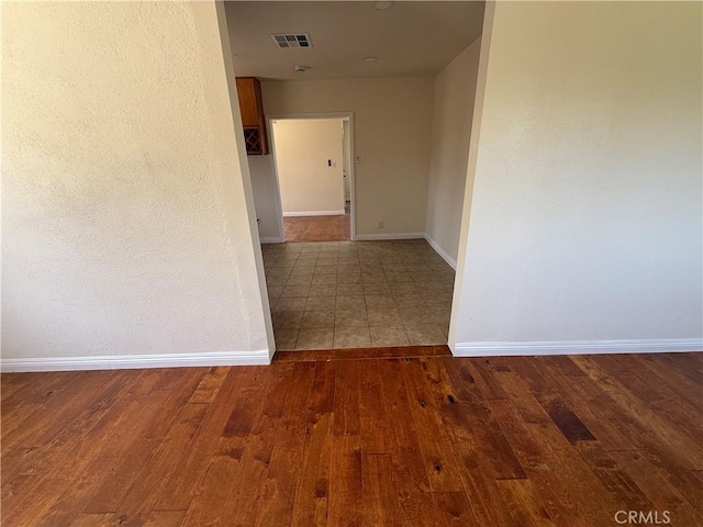 hallway with baseboards and wood finished floors