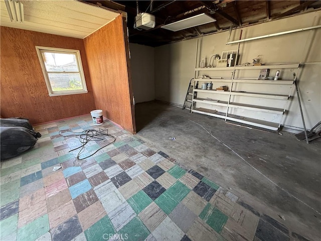 garage featuring a garage door opener and wood walls