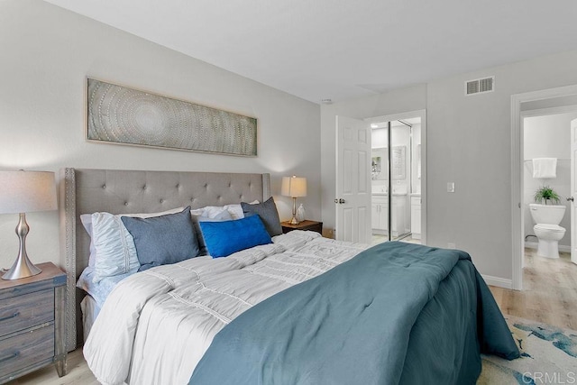 bedroom featuring light wood-type flooring, connected bathroom, and baseboards