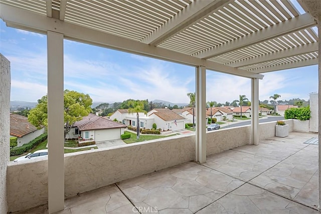 view of patio featuring a residential view, a pergola, and a balcony