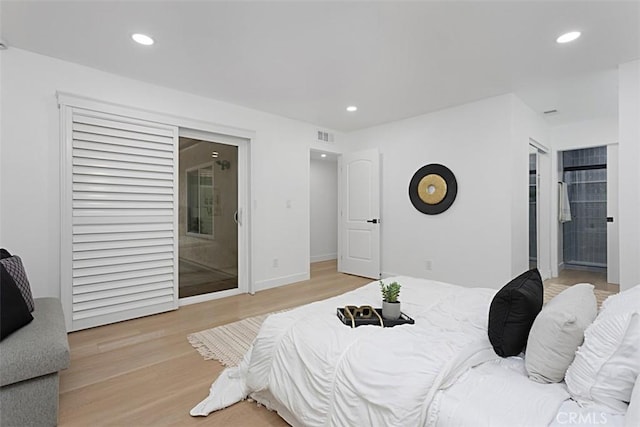 bedroom with recessed lighting and light wood finished floors