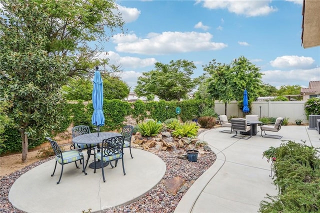 1436 Via Rojas, Hemet, CA 92545 - view of patio with outdoor dining area, a fenced backyard, and central AC unit