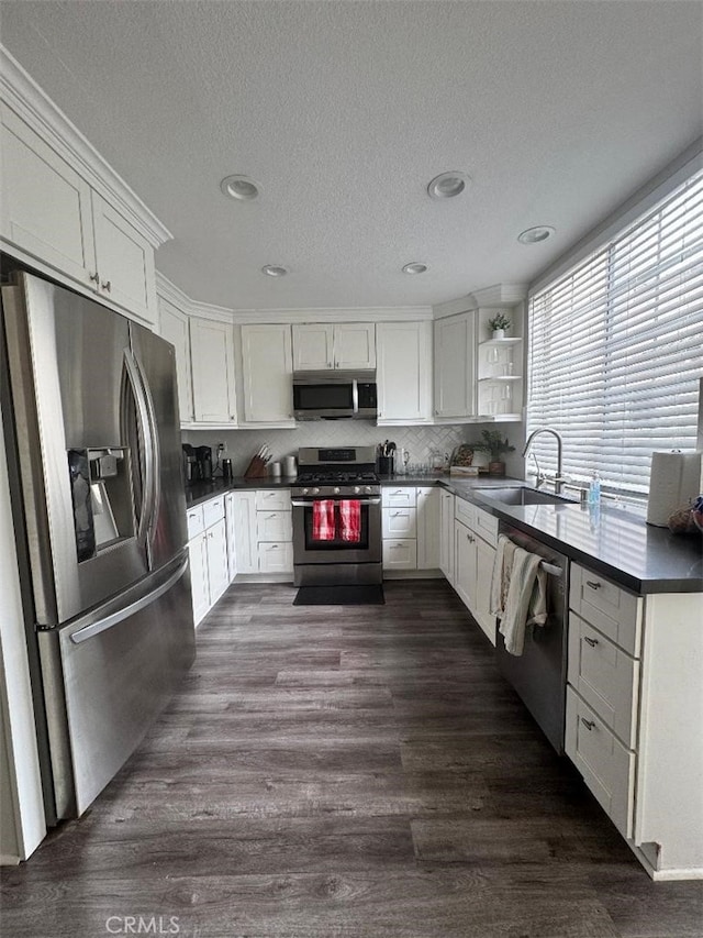 170 Agostino, Irvine, CA 92614 - kitchen featuring stainless steel appliances, a sink, dark countertops, white cabinetry, and open shelves