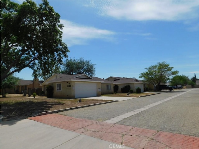 38625 25th St E, Palmdale, CA 93550 - ranch-style house with decorative driveway, an attached garage, and stucco siding
