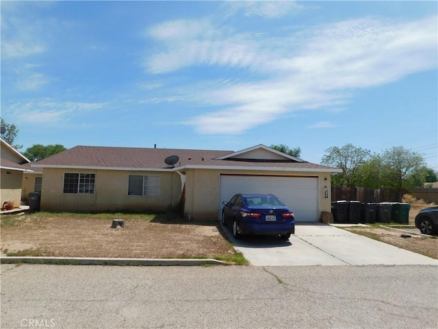 38625 25th St E, Palmdale, CA 93550 - ranch-style home featuring concrete driveway, an attached garage, and stucco siding