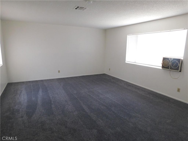 38625 25th St E, Palmdale, CA 93550 - spare room with dark colored carpet, baseboards, and a textured ceiling
