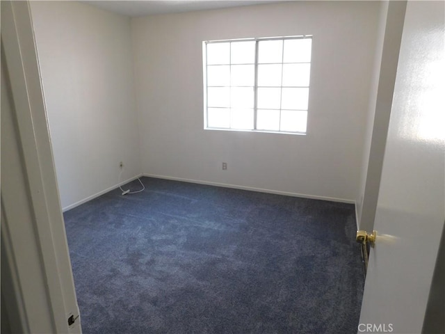 38625 25th St E, Palmdale, CA 93550 - spare room featuring dark carpet and baseboards