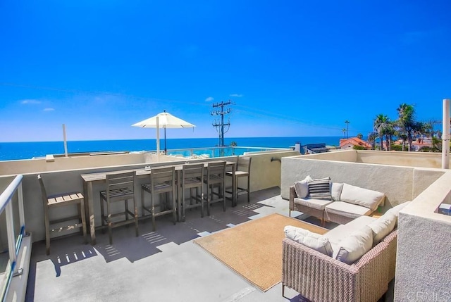 view of patio with an outdoor living space and a water view