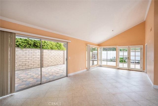 spare room featuring baseboards, french doors, crown molding, light tile patterned floors, and high vaulted ceiling
